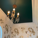 Interior painting project with colorful ceiling and decorative wallpaper